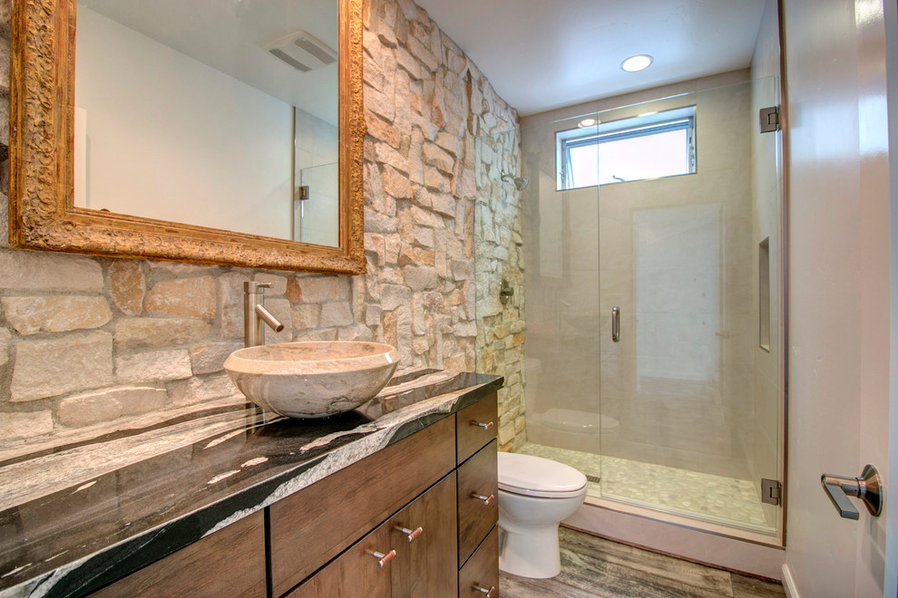 Photo of a medium sized contemporary bathroom in San Diego with a vessel sink, flat-panel cabinets, distressed cabinets, marble worktops, an alcove shower, beige tiles, stone tiles and medium hardwood flooring.