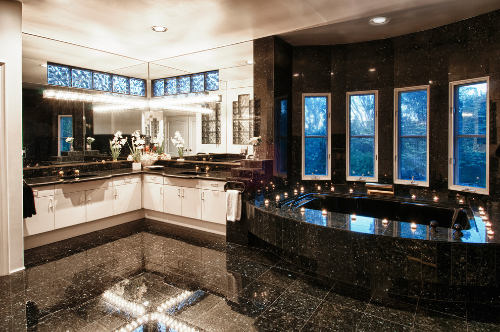 Example of a trendy bathroom design in Orange County with flat-panel cabinets, white cabinets and an undermount tub