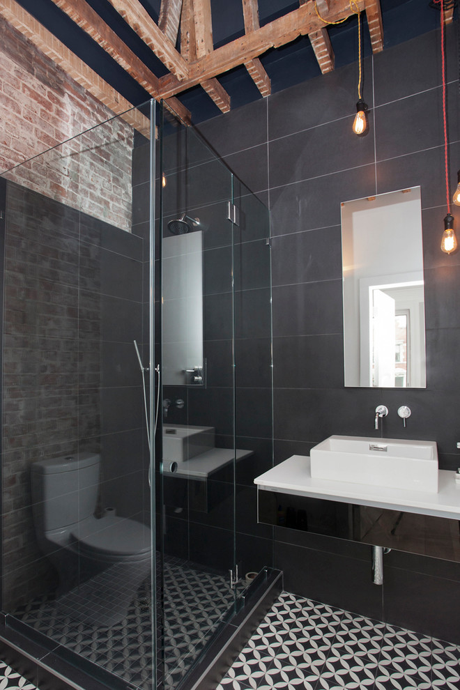 This is an example of a medium sized contemporary shower room bathroom in New York with a vessel sink, a corner shower, grey tiles and grey walls.