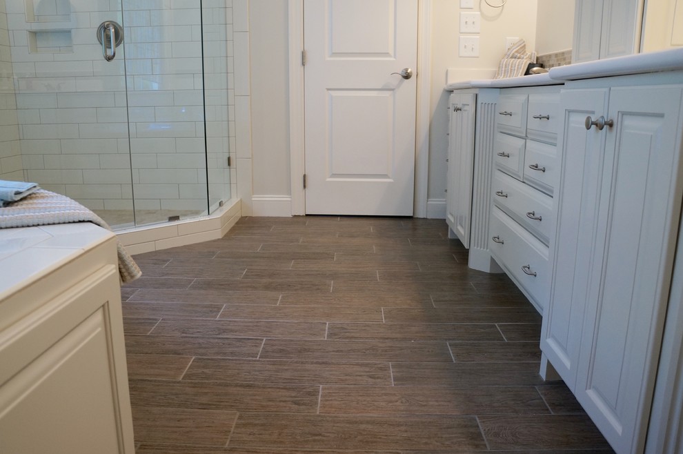 Mid-sized country gray tile and porcelain tile porcelain tile bathroom photo in Raleigh with raised-panel cabinets, gray cabinets, marble countertops and white walls