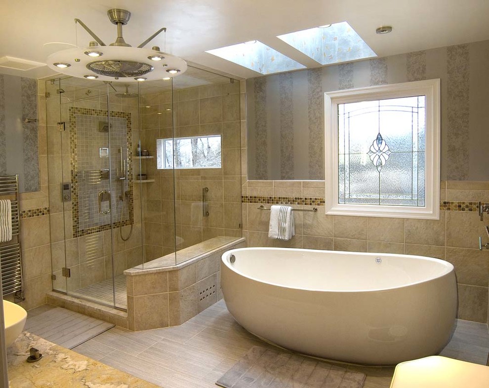 Mid-sized elegant master beige tile and porcelain tile porcelain tile and gray floor bathroom photo in Philadelphia with furniture-like cabinets, medium tone wood cabinets, a two-piece toilet, gray walls, a vessel sink, granite countertops, a hinged shower door and beige countertops