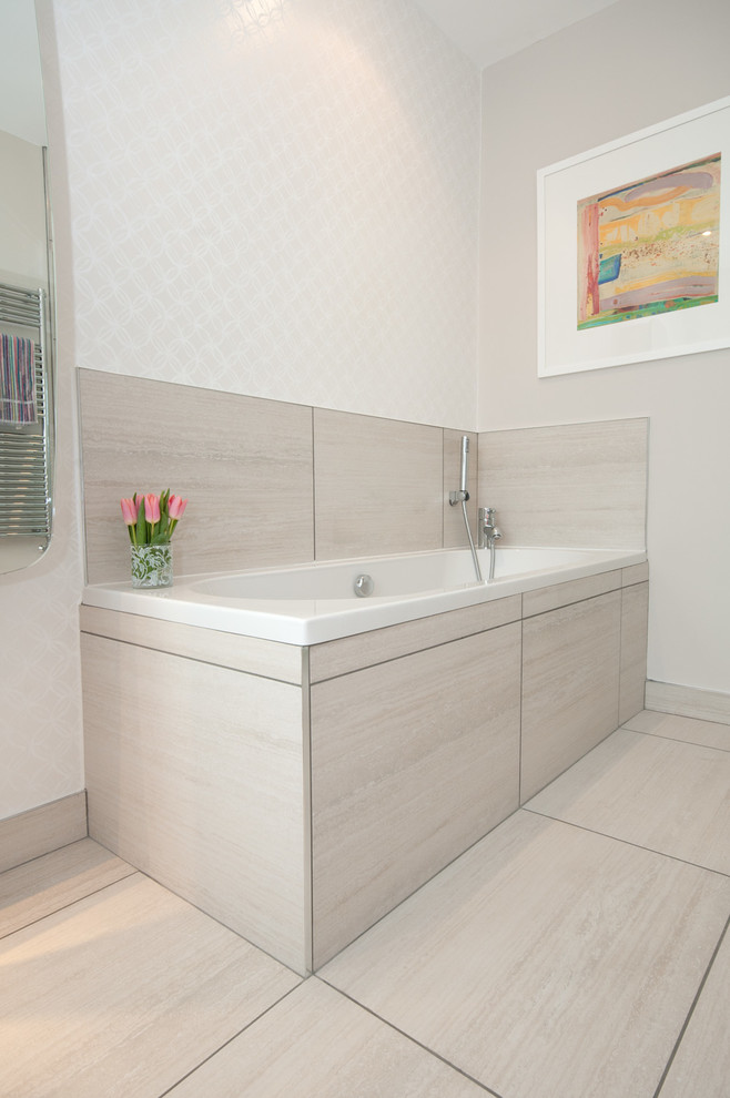 Photo of a large contemporary ensuite bathroom in Belfast with medium wood cabinets, a freestanding bath, a walk-in shower, a wall mounted toilet, beige tiles and porcelain flooring.