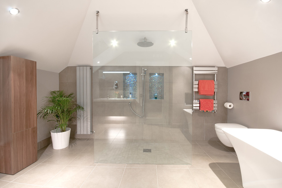 Cette image montre une grande salle de bain principale design en bois brun avec une baignoire indépendante, une douche ouverte, WC suspendus, un carrelage beige et un sol en carrelage de porcelaine.