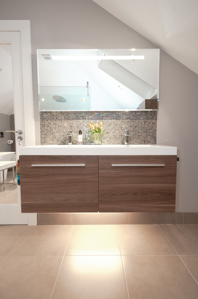 Photo of a large contemporary ensuite bathroom in Belfast with medium wood cabinets, a freestanding bath, a walk-in shower, a wall mounted toilet, beige tiles and porcelain flooring.