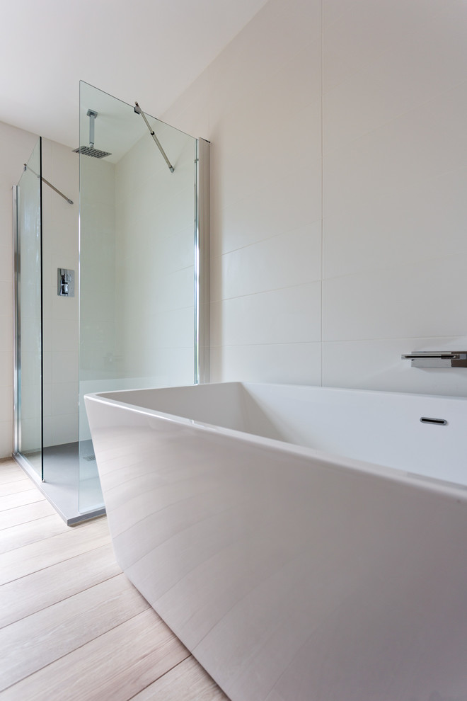 Inspiration for a medium sized scandi family bathroom in Belfast with flat-panel cabinets, white cabinets, a freestanding bath, a walk-in shower, beige tiles, porcelain tiles, beige walls and porcelain flooring.