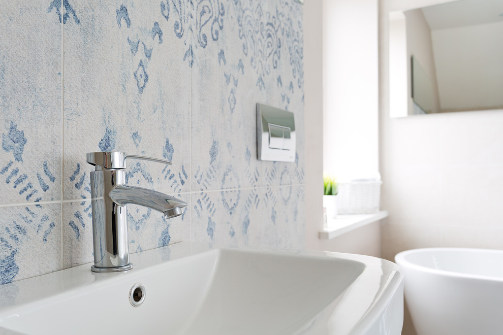 Medium sized scandi ensuite bathroom in Belfast with white cabinets, a freestanding bath, a walk-in shower, blue tiles, porcelain tiles, white walls and porcelain flooring.