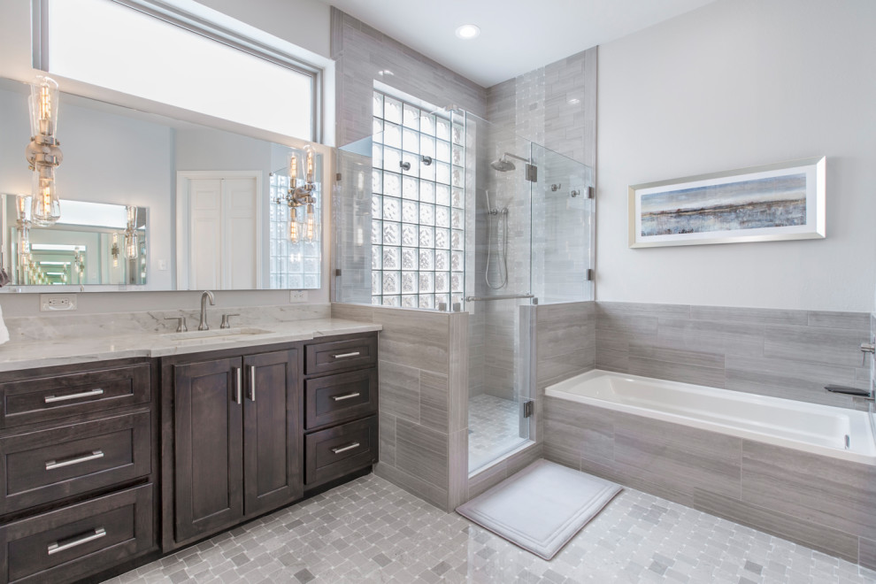 Example of a mid-sized minimalist master gray tile and ceramic tile mosaic tile floor and gray floor bathroom design in Other with shaker cabinets, brown cabinets, a two-piece toilet, gray walls, an undermount sink, quartzite countertops, a hinged shower door and beige countertops