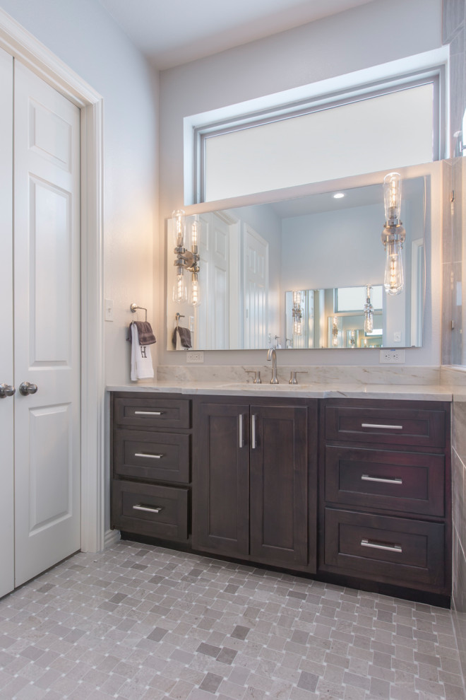Bathroom - mid-sized modern master gray tile and ceramic tile mosaic tile floor and gray floor bathroom idea in Other with shaker cabinets, brown cabinets, a two-piece toilet, gray walls, an undermount sink, quartzite countertops, a hinged shower door and beige countertops