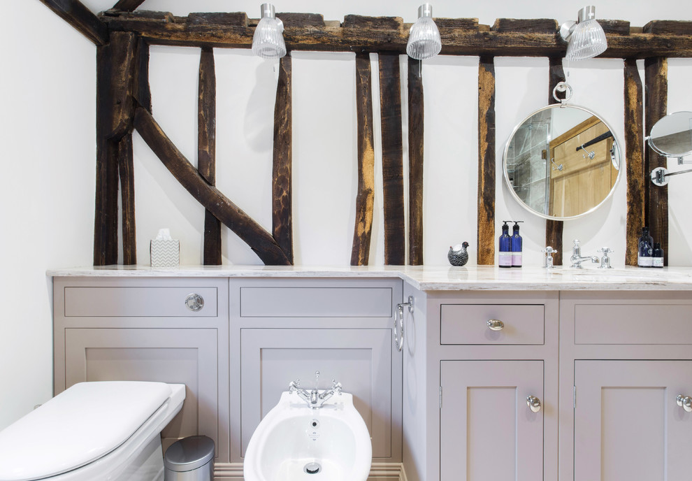 Inspiration for a small country family bathroom in Sussex with shaker cabinets, beige cabinets, a built-in bath, a walk-in shower, white walls, an integrated sink, solid surface worktops, an open shower, beige worktops, grey tiles, porcelain tiles, mosaic tile flooring, beige floors and a one-piece toilet.
