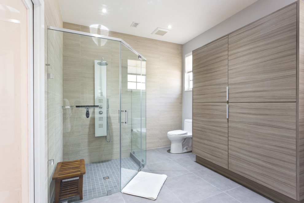 This is an example of a large modern ensuite bathroom in Miami with a vessel sink, flat-panel cabinets, grey cabinets, engineered stone worktops, a corner shower, a one-piece toilet, multi-coloured tiles, porcelain tiles, white walls and porcelain flooring.