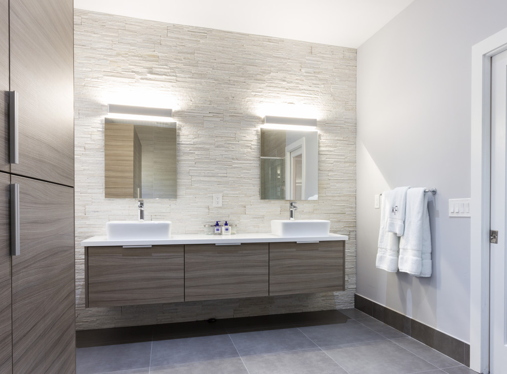Design ideas for a large modern ensuite bathroom in Miami with a vessel sink, flat-panel cabinets, grey cabinets, engineered stone worktops, a one-piece toilet, porcelain tiles, white walls, porcelain flooring and beige tiles.