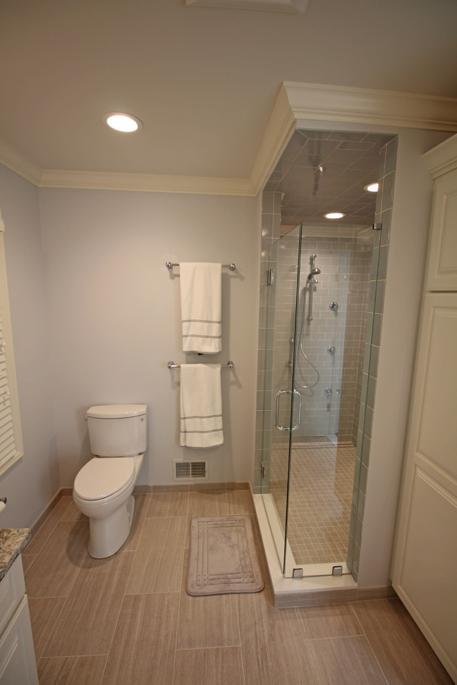 Inspiration for a mid-sized timeless master gray tile and ceramic tile ceramic tile and beige floor alcove shower remodel in Detroit with raised-panel cabinets, white cabinets, a two-piece toilet, gray walls, an undermount sink, quartz countertops and a hinged shower door