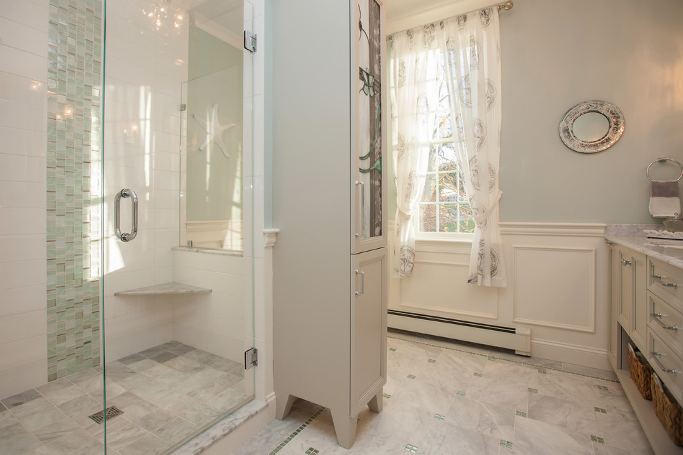Large beach style ensuite bathroom in Boston with recessed-panel cabinets, grey cabinets, a built-in bath, an alcove shower, a two-piece toilet, white tiles, porcelain tiles, green walls, marble flooring, a submerged sink and marble worktops.