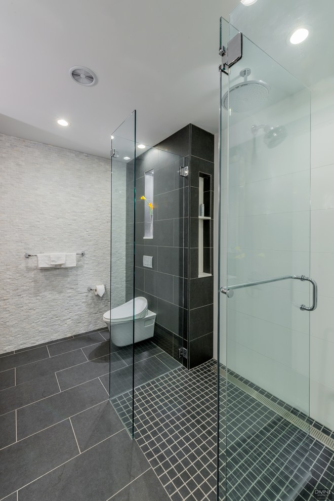 Inspiration for a mid-sized modern 3/4 blue tile and glass tile slate floor and multicolored floor walk-in shower remodel in Boston with flat-panel cabinets, white cabinets, a one-piece toilet, blue walls, an undermount sink, quartz countertops, a hinged shower door and gray countertops