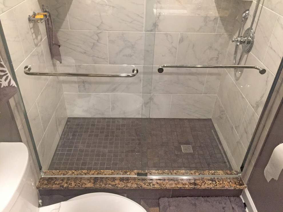Design ideas for a medium sized classic ensuite bathroom in DC Metro with recessed-panel cabinets, brown cabinets, an alcove shower, a two-piece toilet, grey tiles, porcelain tiles, grey walls, porcelain flooring, a submerged sink, granite worktops, grey floors, a sliding door and brown worktops.
