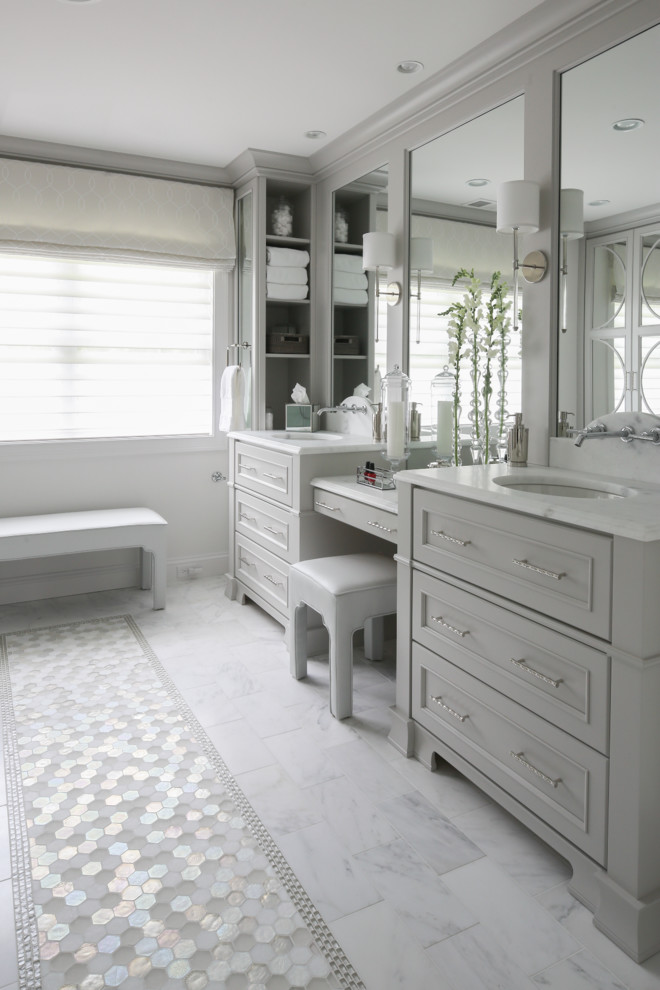 Large classic ensuite bathroom in New York with flat-panel cabinets, grey cabinets, a two-piece toilet, stone tiles, grey walls, marble flooring, a submerged sink and marble worktops.