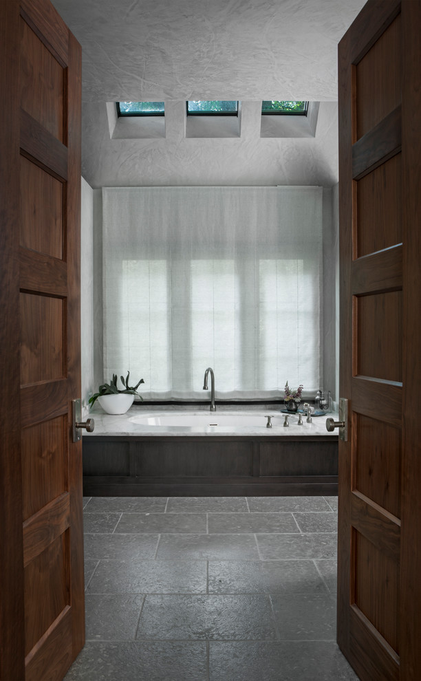 This is an example of a large country bathroom in Grand Rapids with white walls.
