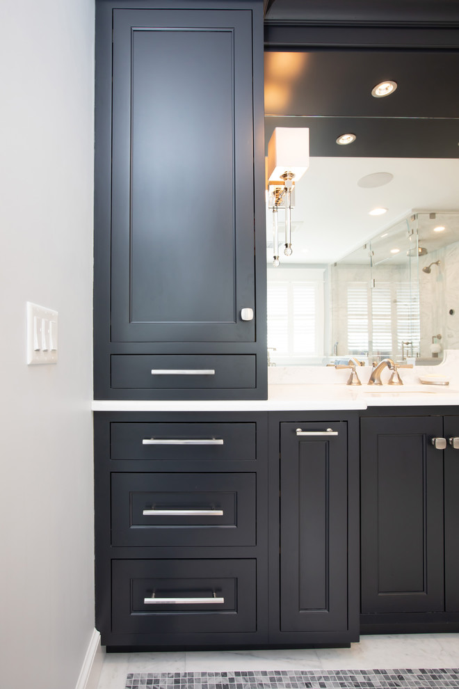 Large contemporary ensuite bathroom in Boston with beaded cabinets, dark wood cabinets, a freestanding bath, a built-in shower, a one-piece toilet, white tiles, marble tiles, blue walls, marble flooring, a submerged sink, engineered stone worktops, white floors, a hinged door and white worktops.