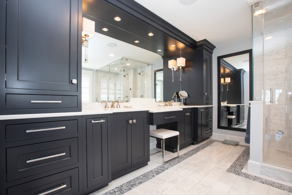 Photo of a large contemporary ensuite bathroom in Boston with beaded cabinets, dark wood cabinets, a freestanding bath, a built-in shower, a one-piece toilet, white tiles, marble tiles, blue walls, marble flooring, a submerged sink, engineered stone worktops, white floors, a hinged door and white worktops.