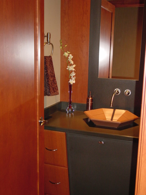 Example of a small trendy 3/4 gray tile and stone slab dark wood floor bathroom design in Milwaukee with flat-panel cabinets, medium tone wood cabinets, a one-piece toilet, beige walls, a vessel sink and quartz countertops