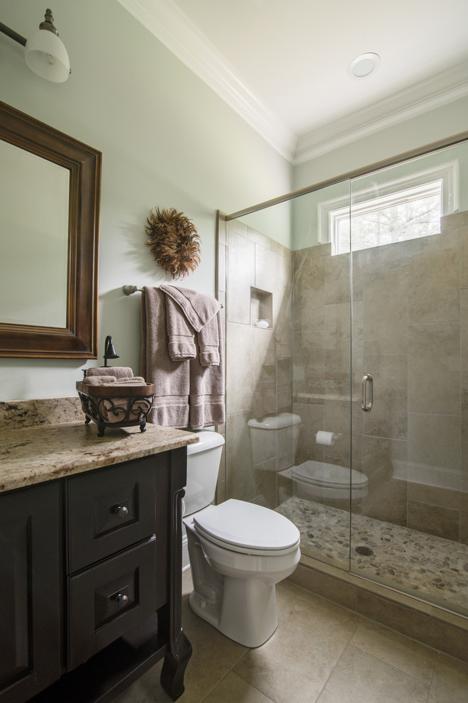 Inspiration for a mid-sized transitional 3/4 beige tile and porcelain tile ceramic tile and beige floor alcove shower remodel in Charlotte with shaker cabinets, dark wood cabinets, an undermount sink, granite countertops, a two-piece toilet, gray walls and a hinged shower door