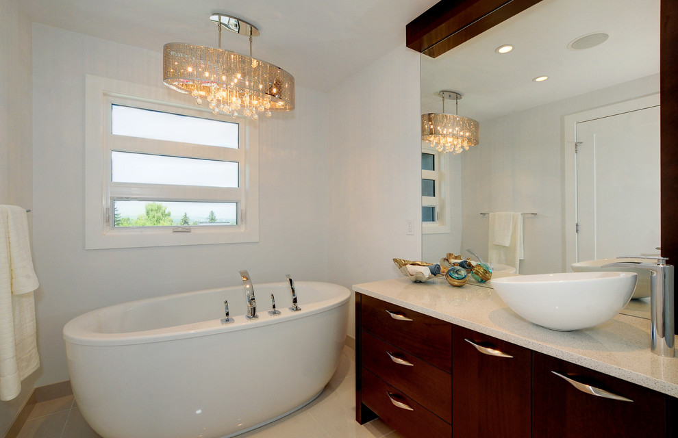 Example of a trendy freestanding bathtub design in Calgary with a vessel sink