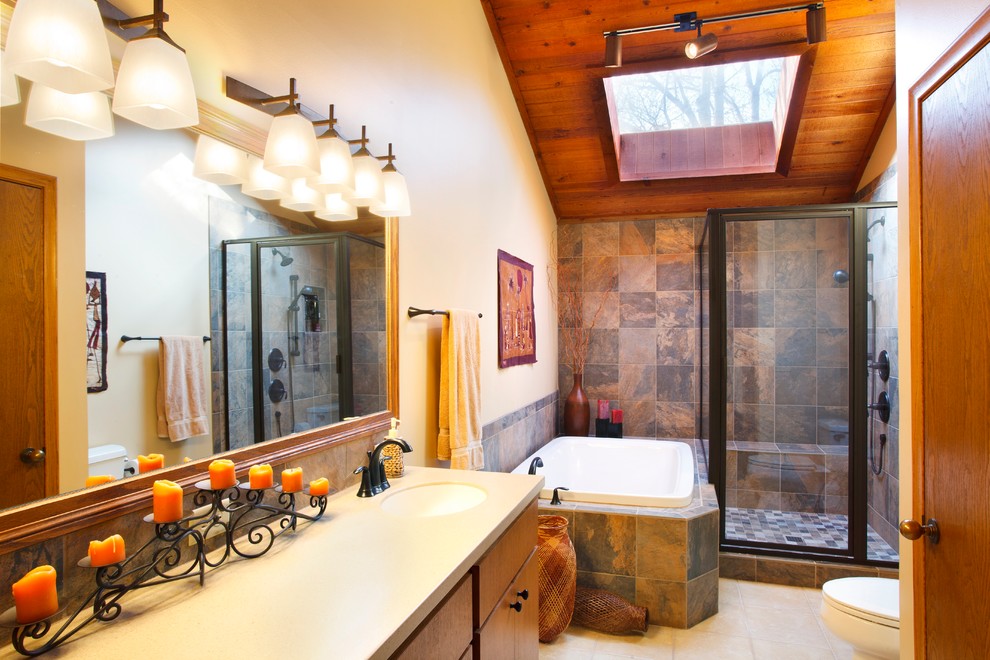 На фото: ванная комната в классическом стиле с врезной раковиной, угловым душем, коричневой плиткой и накладной ванной