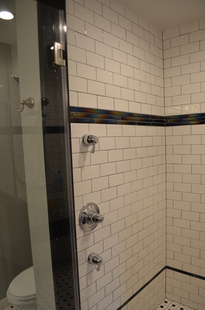 Example of a mid-sized classic 3/4 multicolored tile and matchstick tile linoleum floor alcove shower design in Other with raised-panel cabinets, dark wood cabinets, a two-piece toilet, gray walls, an undermount sink and quartz countertops