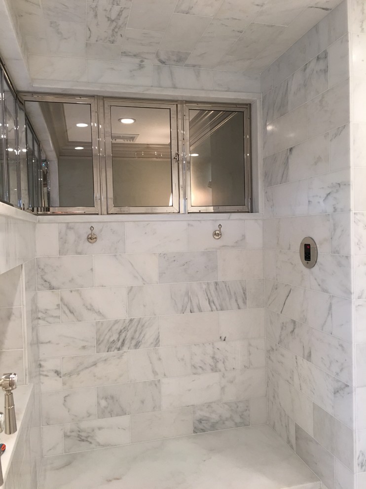 This is an example of a large eclectic ensuite bathroom in New York with a submerged sink, freestanding cabinets, grey cabinets, marble worktops, a freestanding bath, a walk-in shower, a one-piece toilet, white tiles, mosaic tiles, grey walls and mosaic tile flooring.