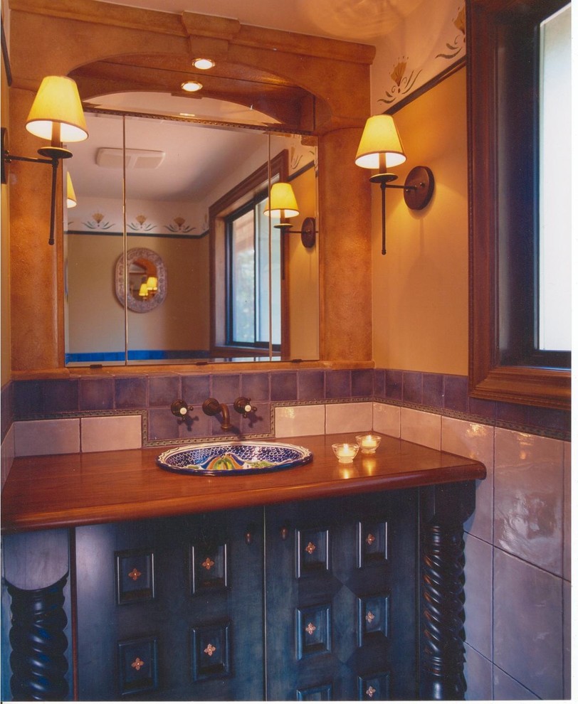 Rustic bathroom in Vancouver with wooden worktops and blue cabinets.
