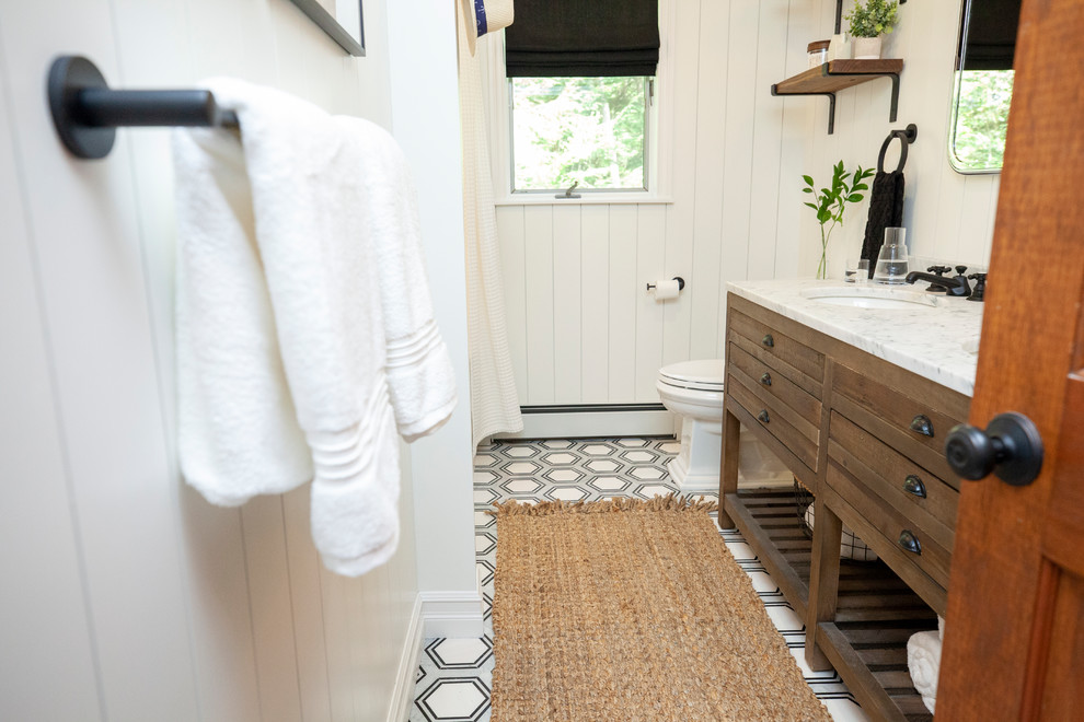 Inspiration for a mid-sized country kids' ceramic tile marble floor and black floor bathroom remodel in New York with distressed cabinets, a two-piece toilet, white walls, an undermount sink and marble countertops