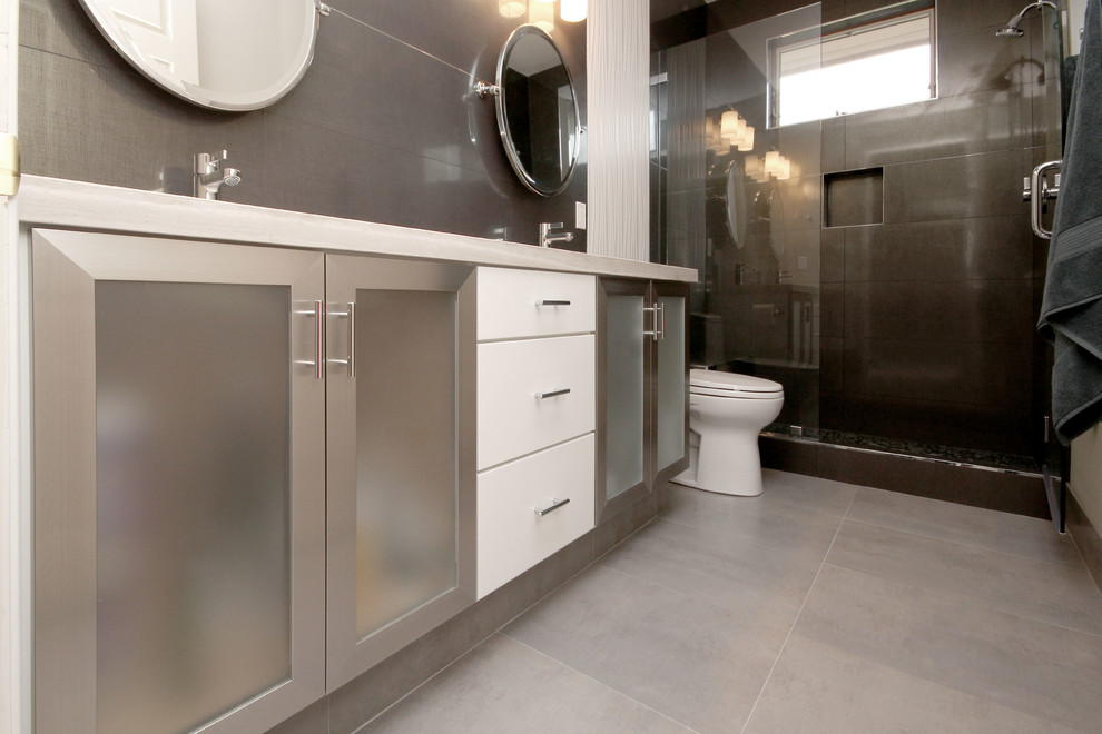 Example of a mid-sized trendy kids' porcelain tile ceramic tile doorless shower design in San Francisco with an undermount sink, marble countertops, gray walls, glass-front cabinets and a one-piece toilet