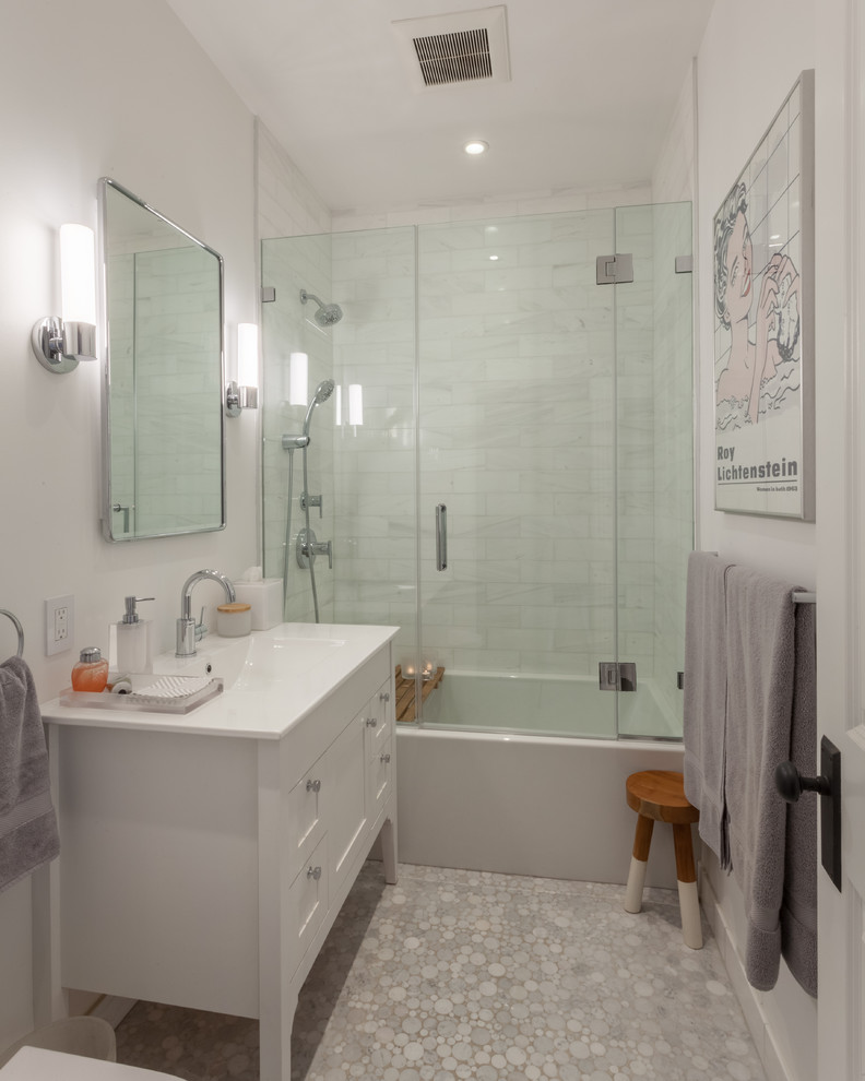 Bathroom - transitional 3/4 white tile and marble tile mosaic tile floor and gray floor bathroom idea in Chicago with furniture-like cabinets, white cabinets, white walls, an integrated sink, a hinged shower door and white countertops