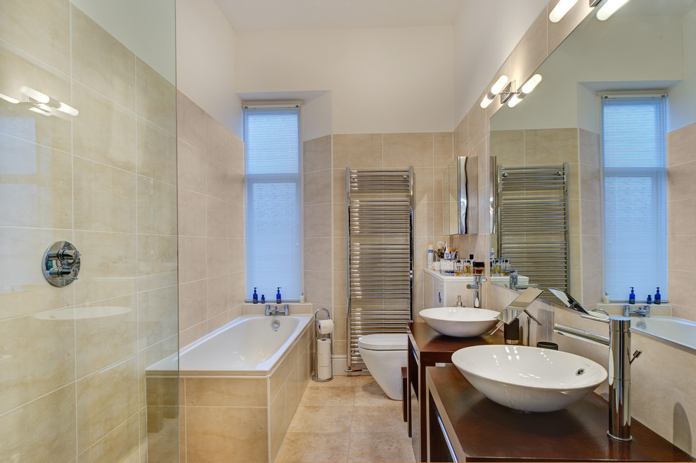 Inspiration for a small traditional ensuite bathroom in Devon with a vessel sink, freestanding cabinets, dark wood cabinets, wooden worktops, a double shower, a wall mounted toilet, beige tiles, ceramic tiles, beige walls and ceramic flooring.