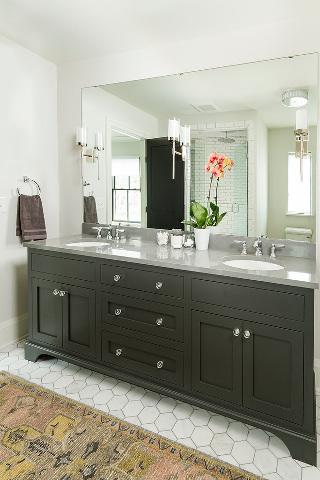 Design ideas for a traditional ensuite bathroom in Minneapolis with shaker cabinets, grey cabinets, a two-piece toilet, white tiles, metro tiles, grey walls, marble flooring, a submerged sink, engineered stone worktops and white floors.