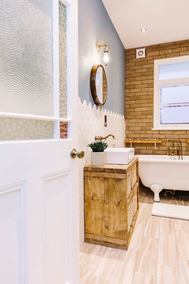 Inspiration for a medium sized rustic family bathroom in London with freestanding cabinets, light wood cabinets, a freestanding bath, a double shower, a one-piece toilet, white tiles, ceramic tiles, blue walls, vinyl flooring, wooden worktops, beige floors and an open shower.