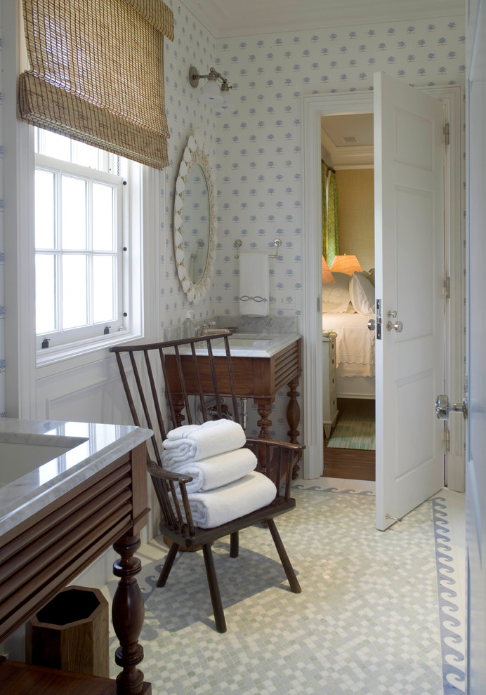 Immagine di una grande stanza da bagno stile marinaro con ante in legno bruno, pareti bianche, lavabo sottopiano e top in marmo