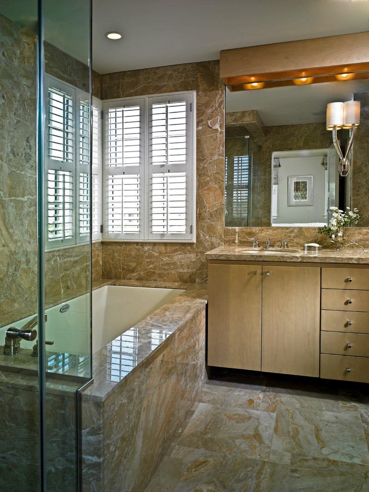 Photo of a small contemporary ensuite bathroom in Miami with a submerged sink, flat-panel cabinets, light wood cabinets, marble worktops, a built-in bath, brown tiles, stone tiles, brown walls and marble flooring.