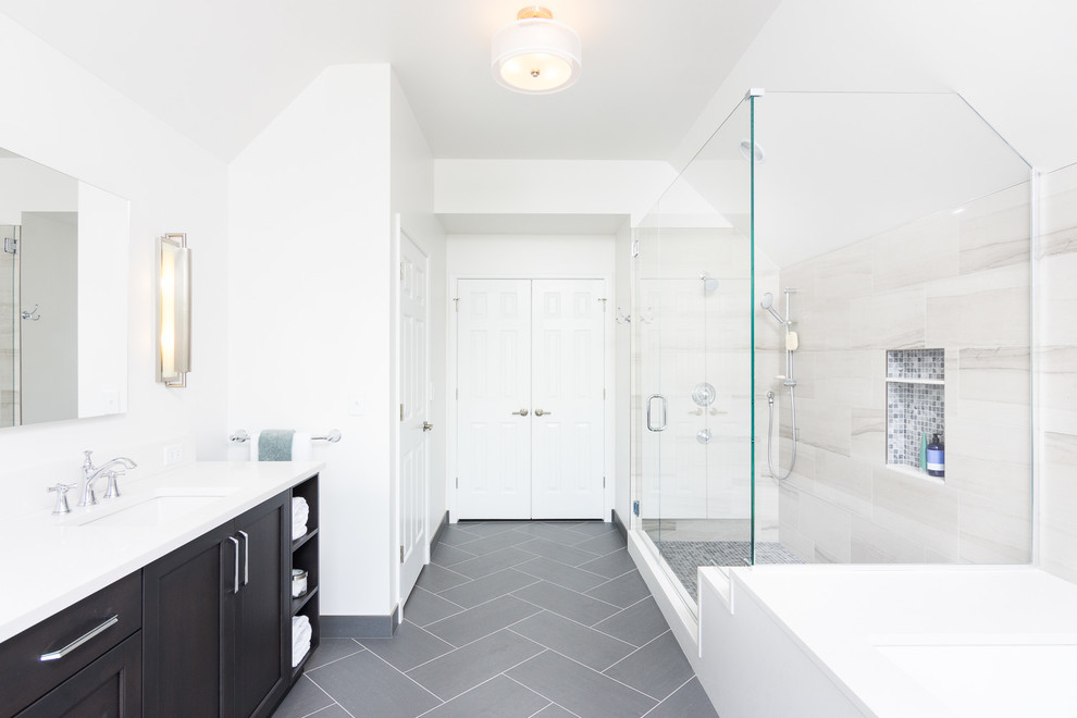Пример оригинального дизайна: большая главная ванная комната в стиле неоклассика (современная классика) с фасадами островного типа, темными деревянными фасадами, угловой ванной, угловым душем, белыми стенами, врезной раковиной, серым полом, душем с распашными дверями и белой столешницей