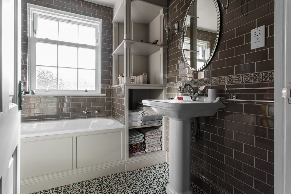 Medium sized contemporary family bathroom in Kent with a built-in bath, a corner shower, a one-piece toilet, grey tiles, metro tiles, grey walls, mosaic tile flooring, a pedestal sink, yellow floors and a hinged door.