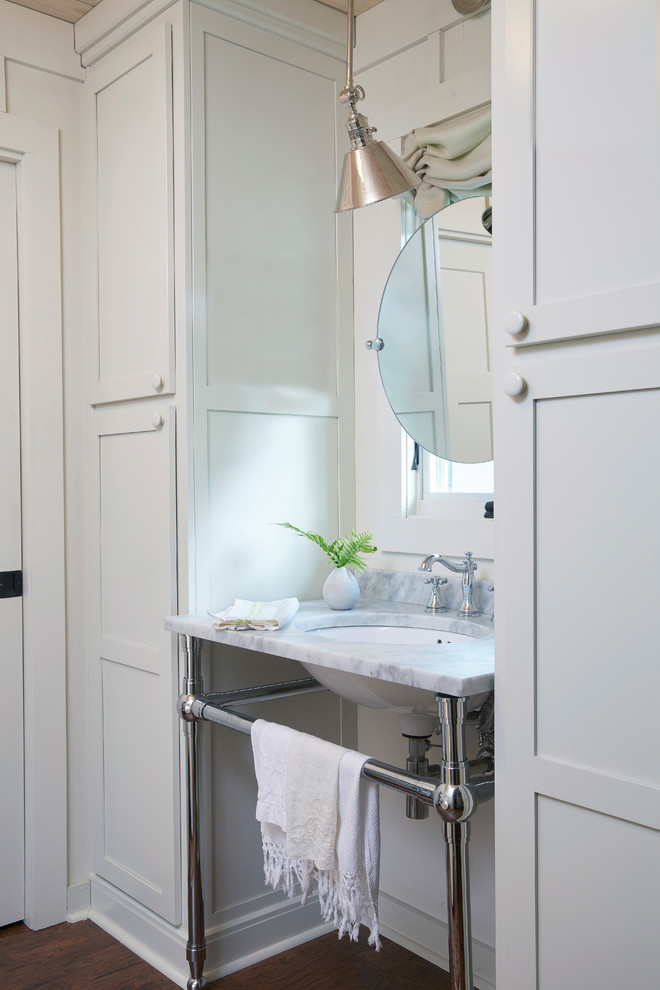 This is an example of a small rural bathroom in Birmingham with shaker cabinets, white cabinets, white walls, dark hardwood flooring, a submerged sink and brown floors.