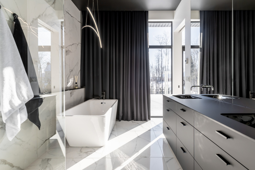 This is an example of a large modern ensuite bathroom in New York with black cabinets, a freestanding bath, a walk-in shower, black and white tiles, ceramic tiles, multi-coloured walls, ceramic flooring, a built-in sink, engineered stone worktops, multi-coloured floors, an open shower, black worktops and double sinks.