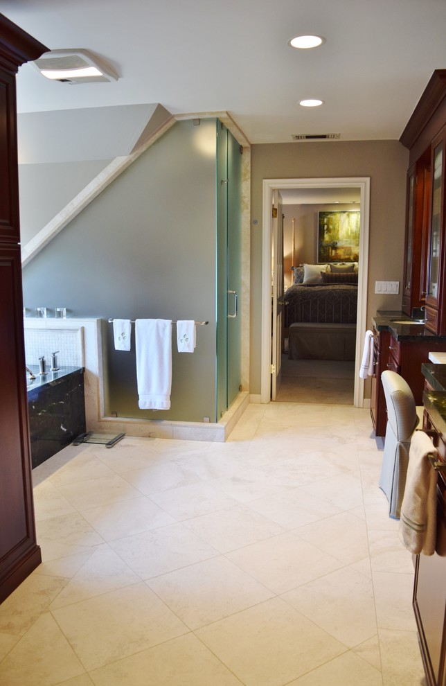 Photo of a large traditional ensuite bathroom in Los Angeles with raised-panel cabinets, a submerged bath, a corner shower, beige tiles, stone tiles, travertine flooring, a submerged sink, granite worktops, beige floors, a hinged door and green worktops.