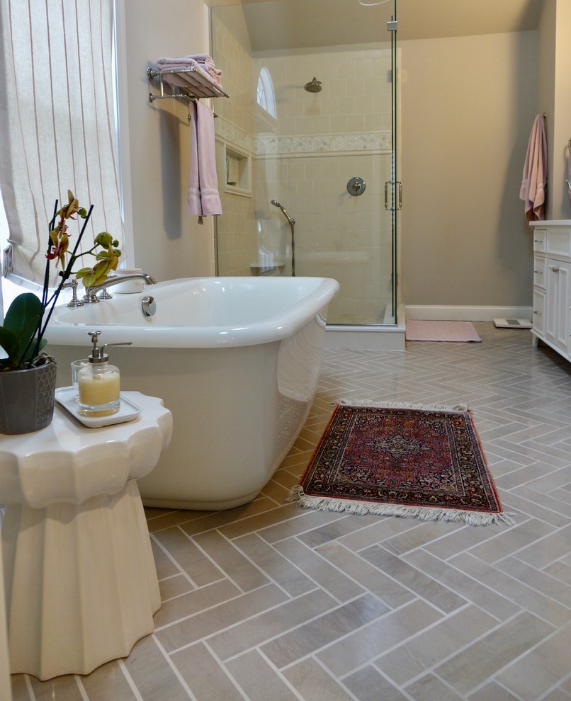Expansive traditional ensuite bathroom in Cleveland with recessed-panel cabinets, white cabinets, a freestanding bath, a corner shower, a two-piece toilet, beige tiles, marble tiles, grey walls, marble flooring, a submerged sink, engineered stone worktops, grey floors and a hinged door.