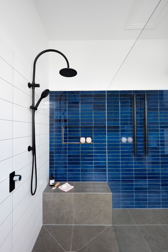Design ideas for a large modern bathroom in Melbourne with flat-panel cabinets, medium wood cabinets, a freestanding bath, a one-piece toilet, blue tiles, metro tiles, white walls, a vessel sink, grey floors, an open shower and white worktops.