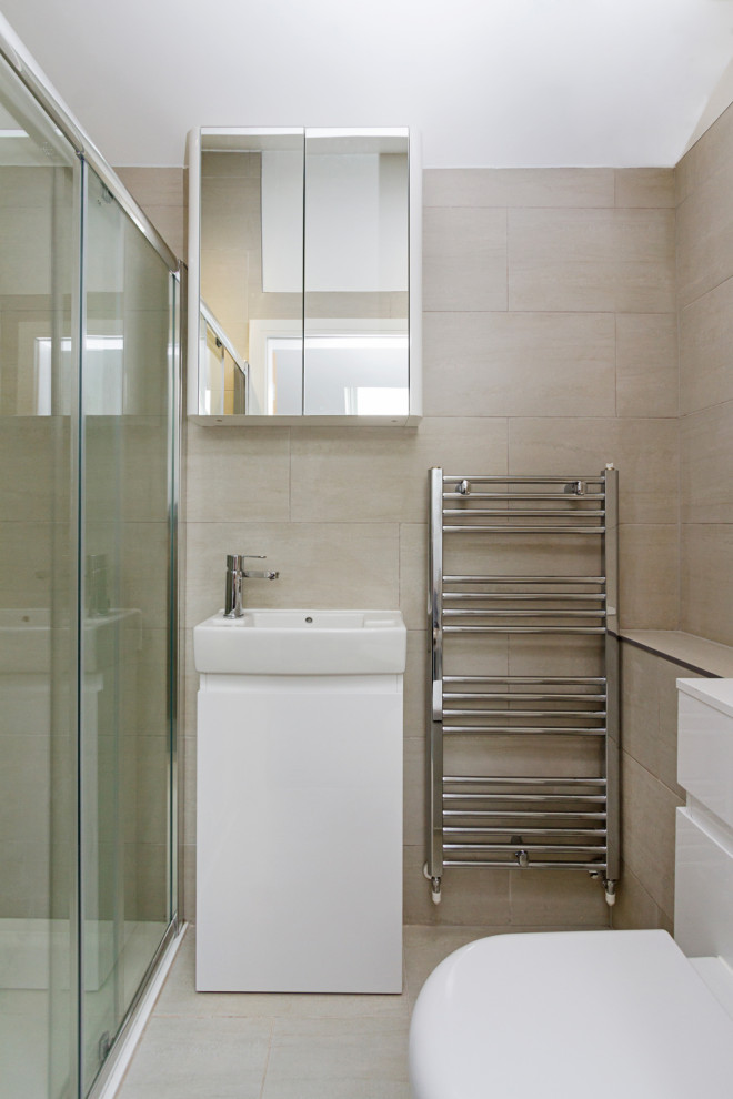 Photo of a medium sized modern ensuite bathroom in West Midlands with flat-panel cabinets, white cabinets, a walk-in shower, a two-piece toilet, beige tiles, beige walls, a console sink, a sliding door, an enclosed toilet, a single sink and a freestanding vanity unit.