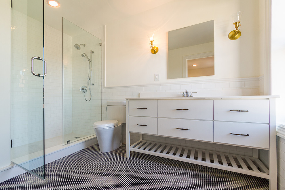 Example of a huge transitional kids' white tile and porcelain tile porcelain tile and black floor bathroom design in New York with flat-panel cabinets, white cabinets, a two-piece toilet, white walls, an undermount sink and quartz countertops