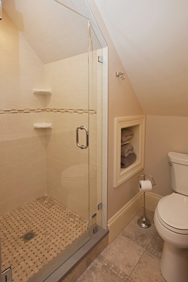 Photo of a medium sized classic ensuite bathroom in Boston with raised-panel cabinets, dark wood cabinets, an alcove shower, a one-piece toilet, beige walls, porcelain flooring, a submerged sink, marble worktops, beige floors and a hinged door.