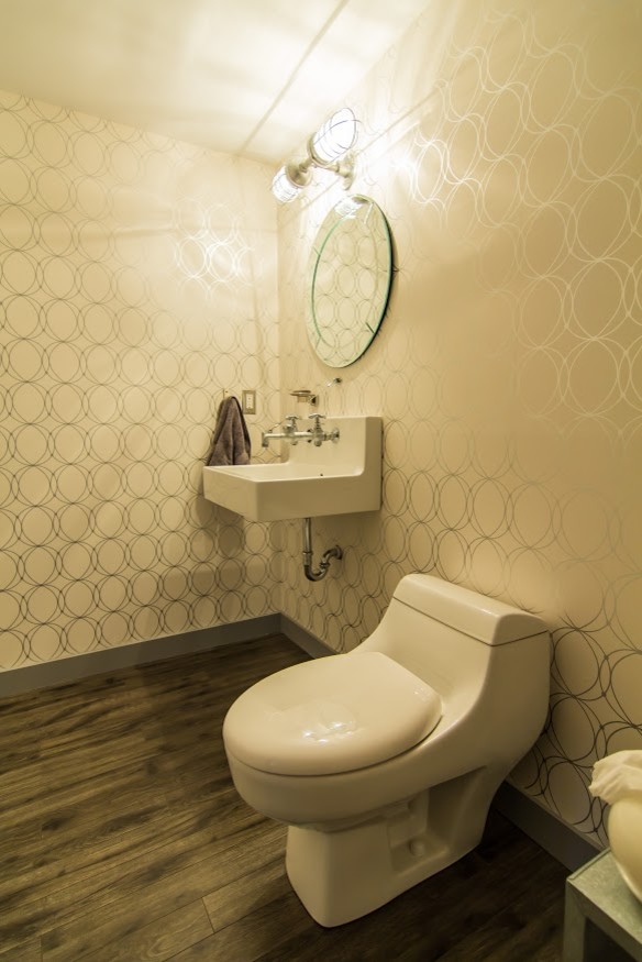 Mittelgroße Moderne Gästetoilette mit Toilette mit Aufsatzspülkasten, beiger Wandfarbe, dunklem Holzboden, Wandwaschbecken, Quarzwerkstein-Waschtisch, braunem Boden, offenen Schränken und grauen Schränken in Vancouver