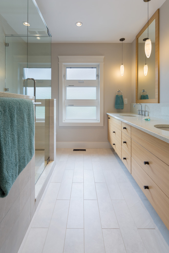 Design ideas for a modern bathroom in Vancouver with flat-panel cabinets and light wood cabinets.